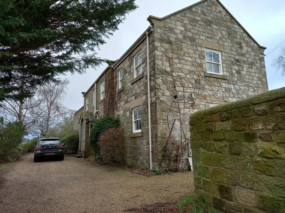 A gritstone house and wall on Hollins Lane, Hampsthwaite